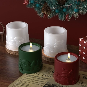 Detailed relief design showing Santa Claus and elk on festive scented candle jars