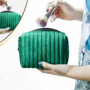 Large green velvet cosmetic bag with quilted texture and makeup brush storage