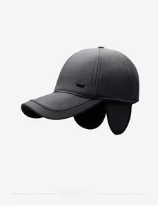 Detail of dark grey winter baseball cap with ear flaps and side metal logo accent
