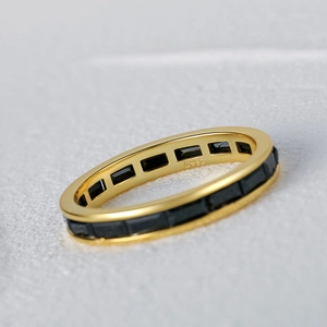 Macro shot of S925 sterling silver gold ring with rectangular black gemstones and stamp