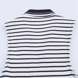 Close-up of the ribbed knit fabric and striped collar on this black and white top