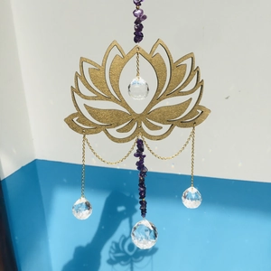 Macro view of golden lotus suncatcher with purple amethyst and faceted crystal balls