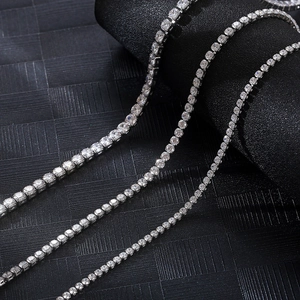 Close-up of hip hop silver tennis chain with sparkling crystals on black background