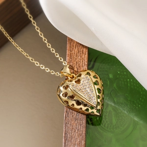 Gold plated heart pendant necklace with zircon stones in a minimalist hollow design