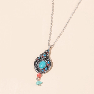 Detail of silver feather pendant necklace with turquoise stones and colorful beads