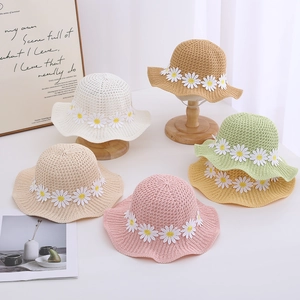 Kids summer straw sun hats in various colors featuring cute daisy flower decorations