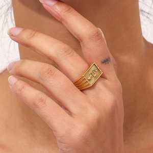 Gold plated stainless steel square signet ring with snakeskin texture shown on hand