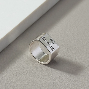 Minimalist silver metal ring featuring engraved NO SMOKING text in retro aesthetic