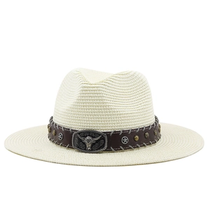 Close-up of western straw hat featuring brown leather band and bull head metal buckle