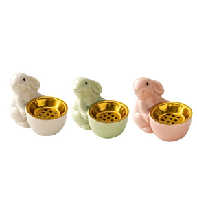 Ceramic bunny incense burners in beige, pink, and green with golden metal filters