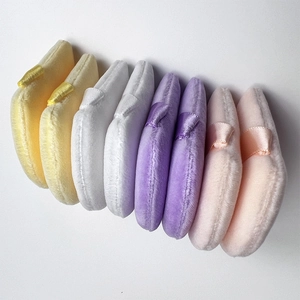 Set of eight velvet makeup puffs in yellow white purple and pink with ribbon handles