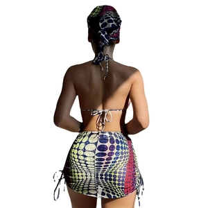 Rear view of polka dot three-piece swimsuit with halter top and drawstring skirt