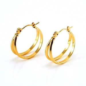 Close-up of golden double-hoop titanium earrings with reflective metallic finish