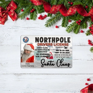 Detail of Santa Claus driver license card on rustic wood with festive Christmas decorations