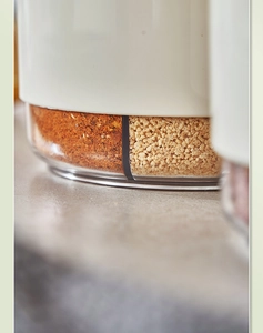 Close-up of divided transparent spice box with white lid and dual storage compartments