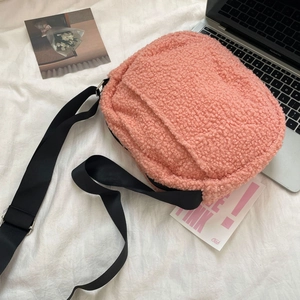 Detailed texture of pink lamb wool crossbody bag with adjustable nylon shoulder strap