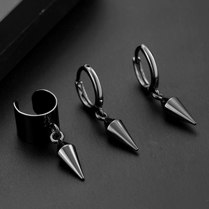 Close-up of black punk earrings set including a wide ear cuff and cone spike drop hoops