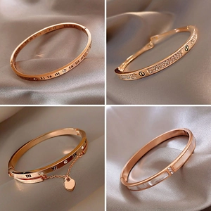 Luxury rose gold bangles with cubic zirconia and Roman numerals on silk background
