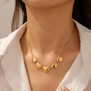 Elegant gold-plated stainless steel necklace featuring five textured heart pendants