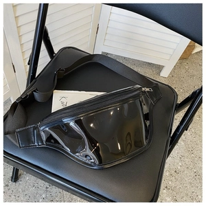 Detail view of the durable silver zipper and black adjustable strap on the clear PVC fanny pack