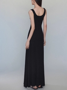 Elegant sleeveless black maxi dress with a slim fit and low back for a minimalist summer look