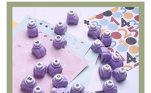 Purple DIY paper punches with various patterns like heart and snowflake for crafts