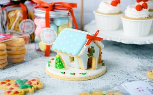 Detailed view of DIY 3D gingerbread house with festive blue icing and sugar ornaments