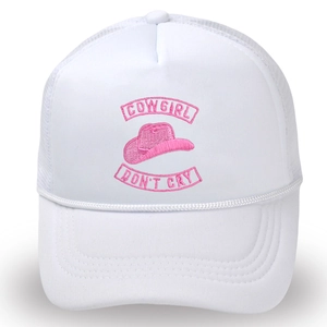 Close-up of pink 'COWGIRL DON'T CRY' embroidery on white mesh trucker cap