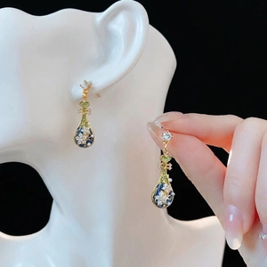 Vintage-style floral drop earrings with blue enamel and pearls on gold-toned metal