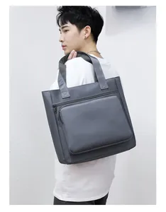Detail of grey waterproof nylon shoulder bag with reinforced handle and large front pocket