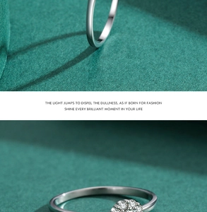 Macro view of a 925 sterling silver ring with delicate pave diamonds on dark green backdrop