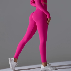 Detailed back view of seamless high waist yoga leggings and long sleeve top in bright pink