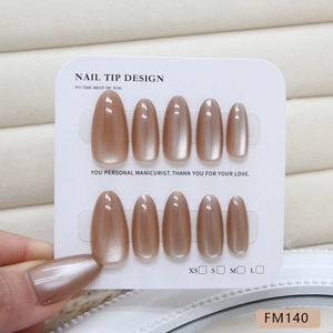Handmade press-on nails in sheer cat eye coffee brown on a size-marked white display card