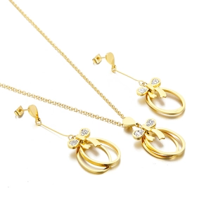 Golden bow jewelry set with sparkling rhinestones and oval pendant necklace earrings