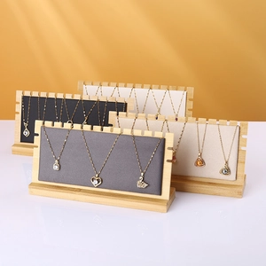 Minimalist bamboo necklace display stand with multi-slot velvet backboard for jewelry storage