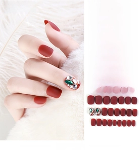 Detail of 24pcs press-on nails with matte red finish and sparkling rhinestone accents