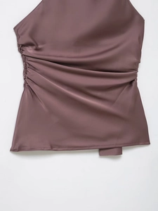 Detailed view of mauve satin halter top featuring elegant side ruching and silky texture