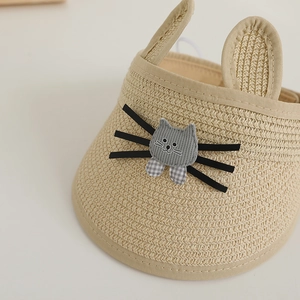 Gros plan d'un chapeau de paille pour enfants avec oreilles et patch de chat mignon