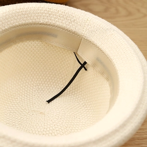 Inside view of cream dome bucket hat with sweatband and elastic windproof strap