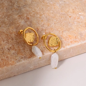 Baroque natural pearl earrings with irregular gold geometric studs on stone