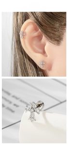 Macro shot of silver cross stud earrings with micro-inlaid zircon and screw back