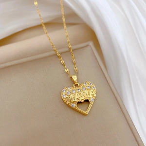 Luxurious gold hollow heart MAMA necklace with crystals on a white silk background