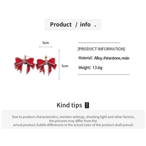 Detail view of red resin bow earrings with rhinestone edges, 5cm size specification