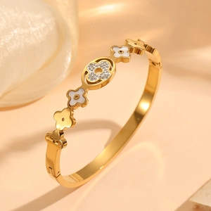 Gold stainless steel flower bracelet featuring white shell petals and sparkling crystals