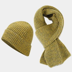 Close-up of thick rib knit texture on mustard yellow and grey winter hat scarf set
