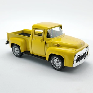 Detailed side view of a vintage yellow pickup truck toy model with silver bumpers