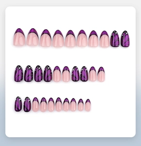 Close-up of purple French almond press-on nails with butterfly wing pattern and pearl finish