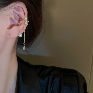 Detailed close-up of zircon butterfly tassel ear cuff with pearl and water drop pendant