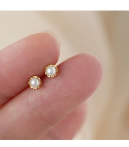 Macro view of 3-4mm mini pearl screw back earrings with vintage gold textured bezel