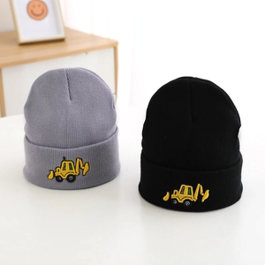 Close-up of grey and black knitted beanies with yellow excavator embroidery for boys